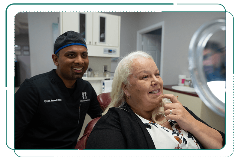 Dr. Sayeedi, Syed Zafar. looking into a mirror with patient smiling